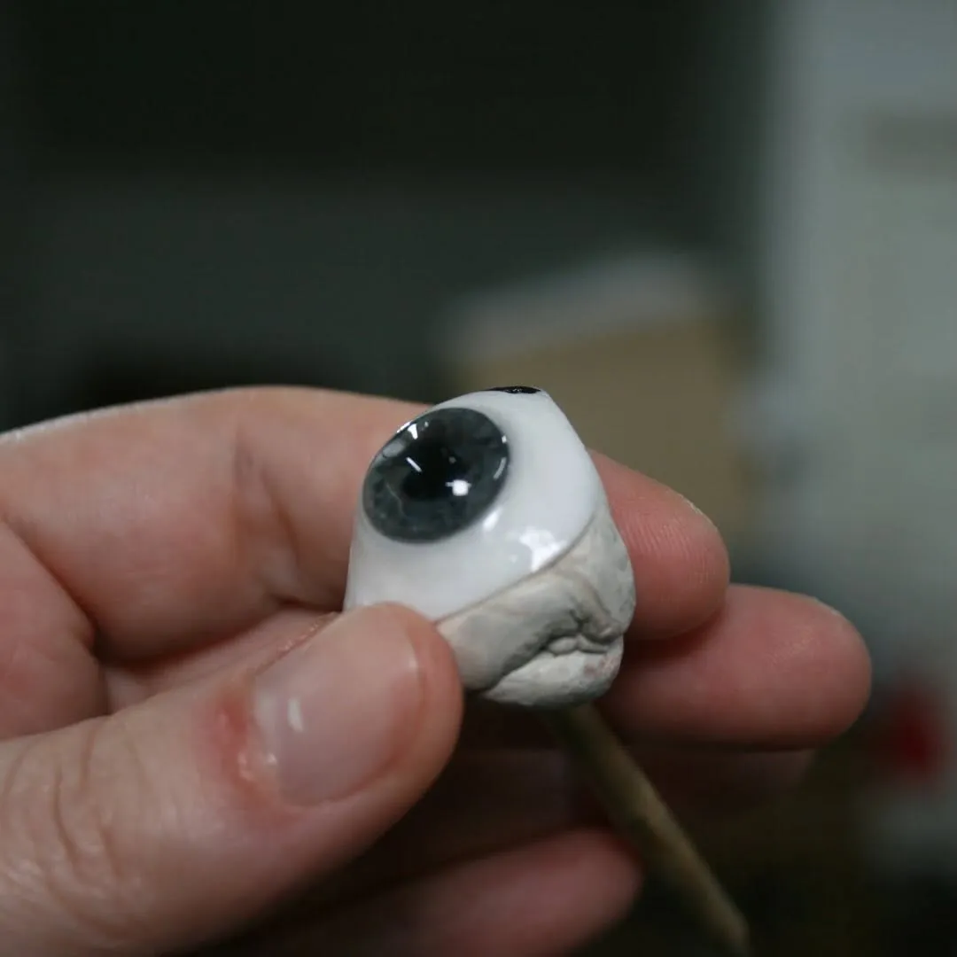 Handmade prosthetic eye fresh from Lorna's studio, showcasing the fine brushwork and individual attention of a skilled ocularist